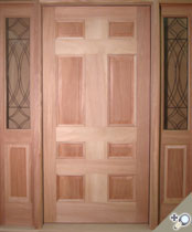 2 1/4 inch thick african mahogany entrance unit with applied moldings, bookmatched raised panels and historic leaded glass.